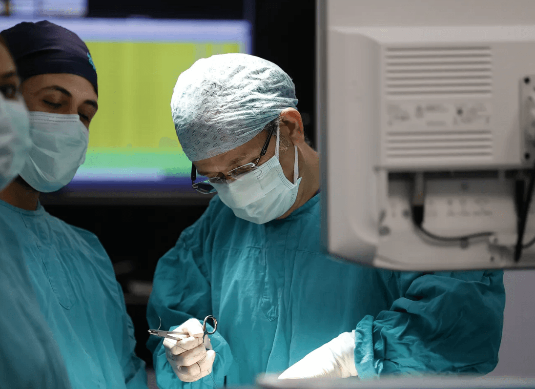 Surgical team performing a minimally invasive operation in a modern operating theatre
